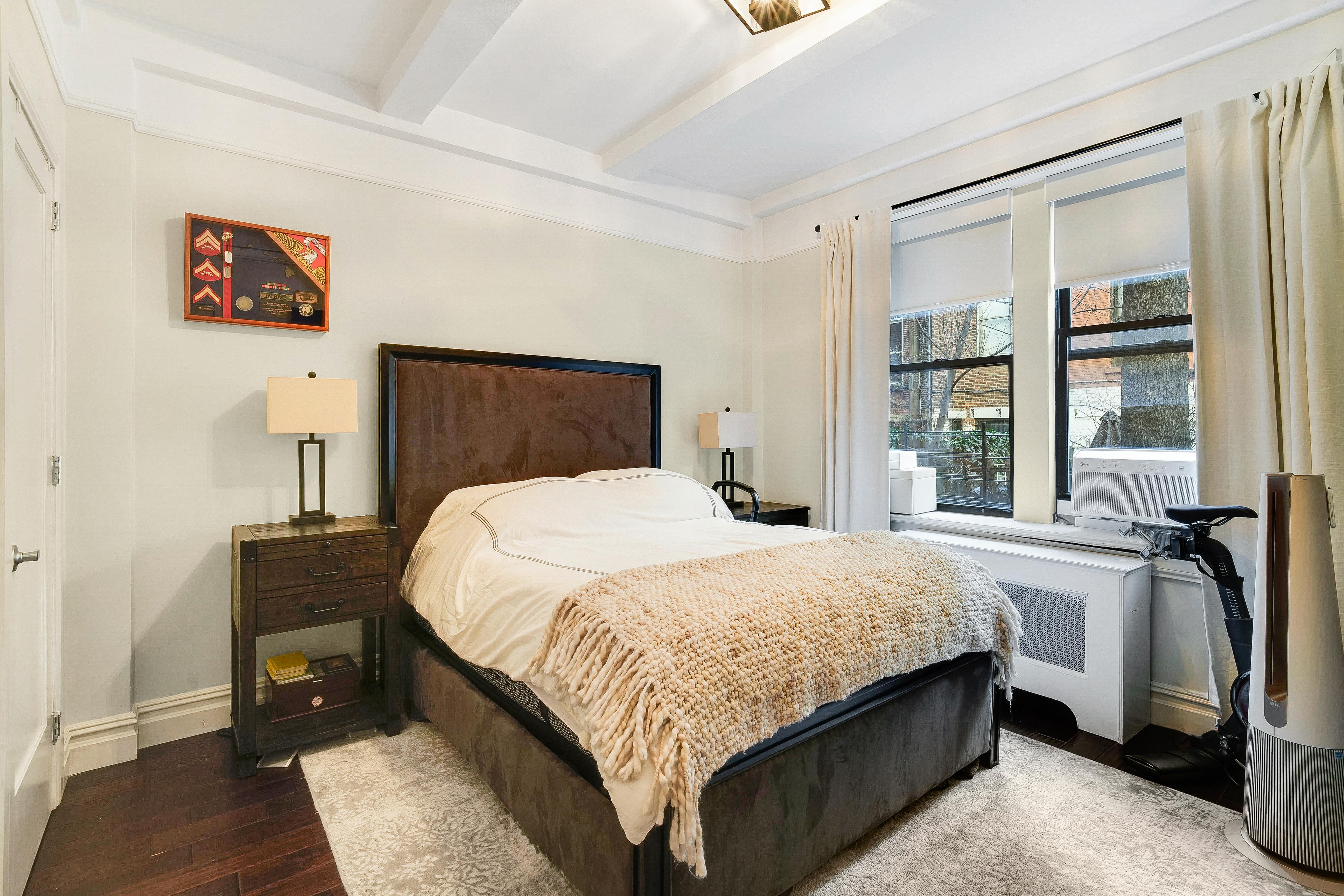 114 West 70th Street Manhattan, NY 10023 - Photo 5 of 9 a bedroom with a bed and a large window