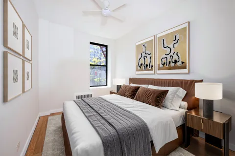 a bedroom with a bed and a painting on the wall