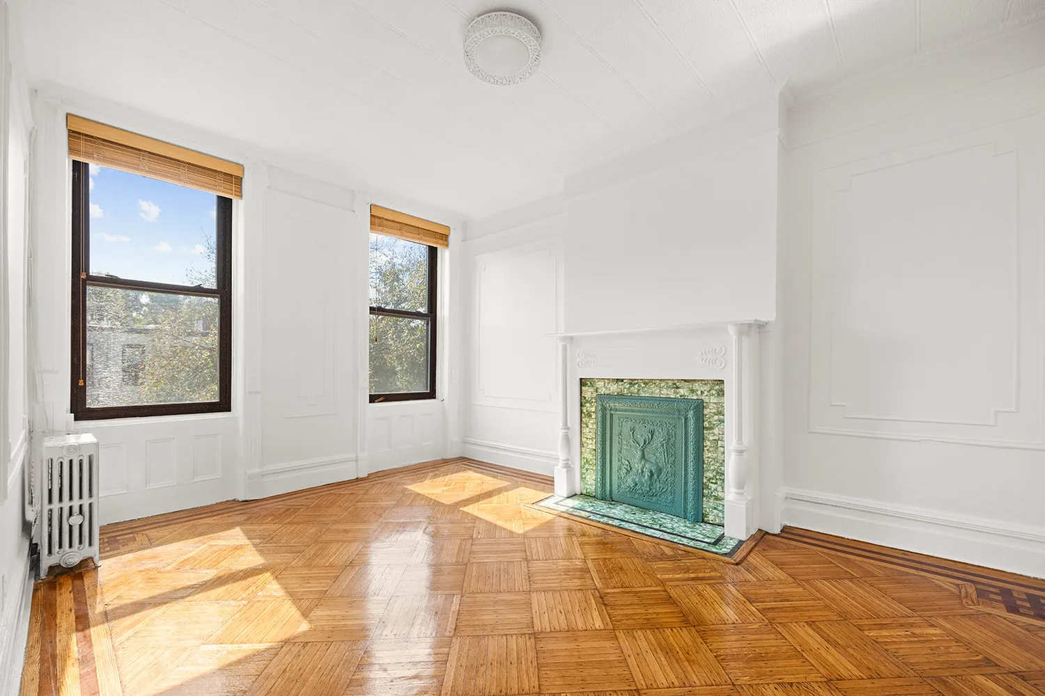 a view of an empty room with window and cabinet