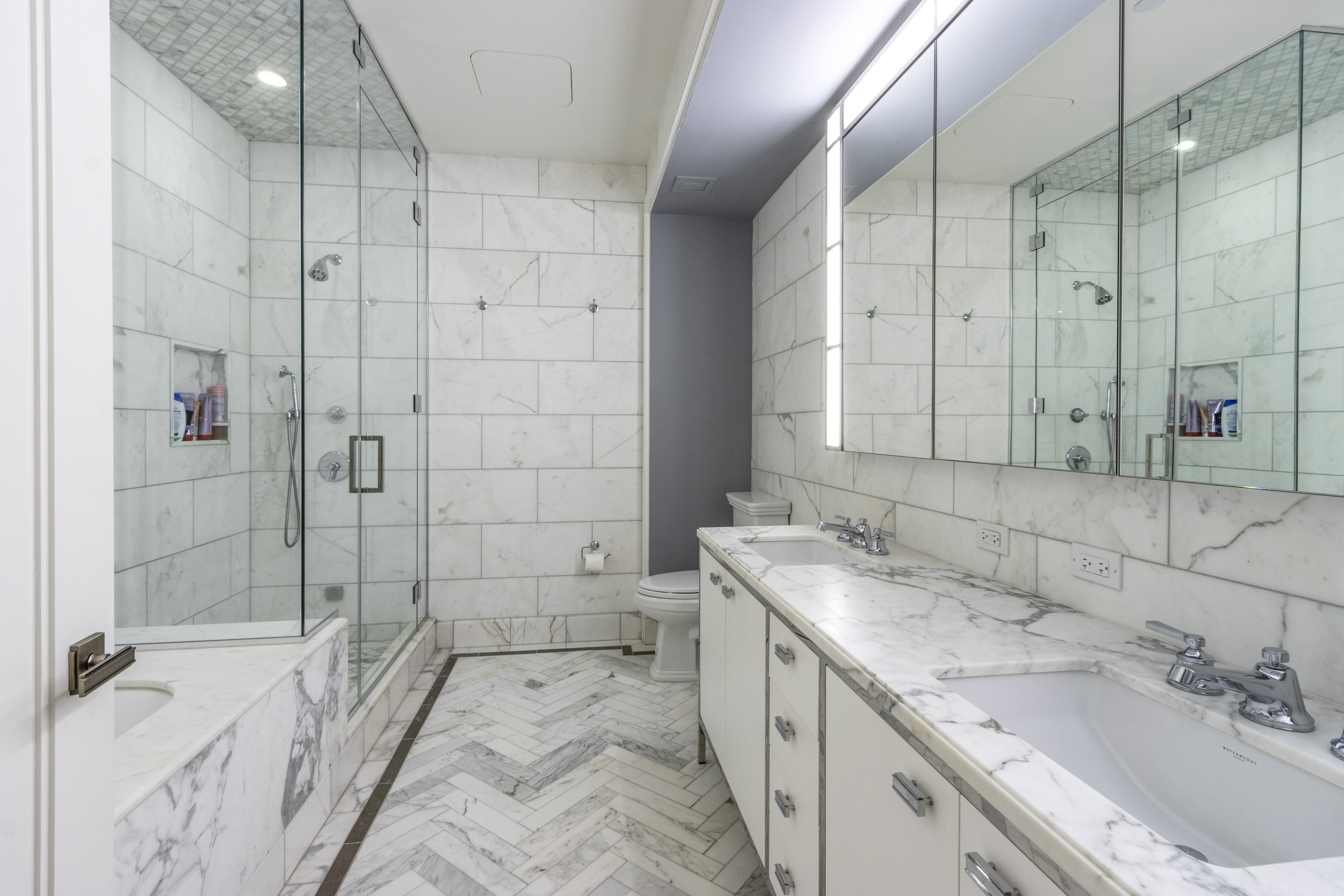 100 Barclay Street, Unit 15P Manhattan, NY 10007 - Photo 19 of 34 a bathroom with a granite countertop sink mirror and shower