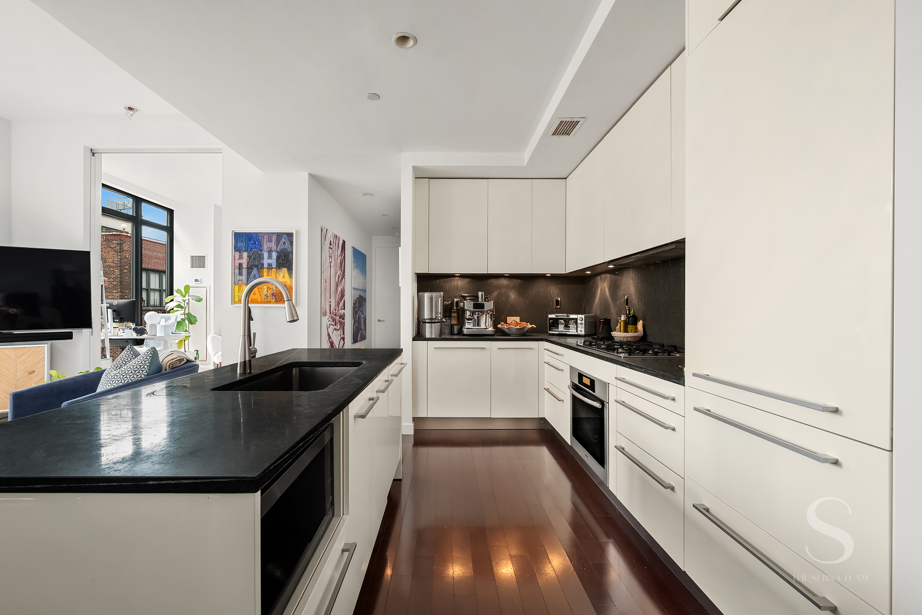 4 West 21st Street, Unit 14A Manhattan, NY 10010 - Photo 4 of 16 a kitchen with granite countertop a sink and white appliances