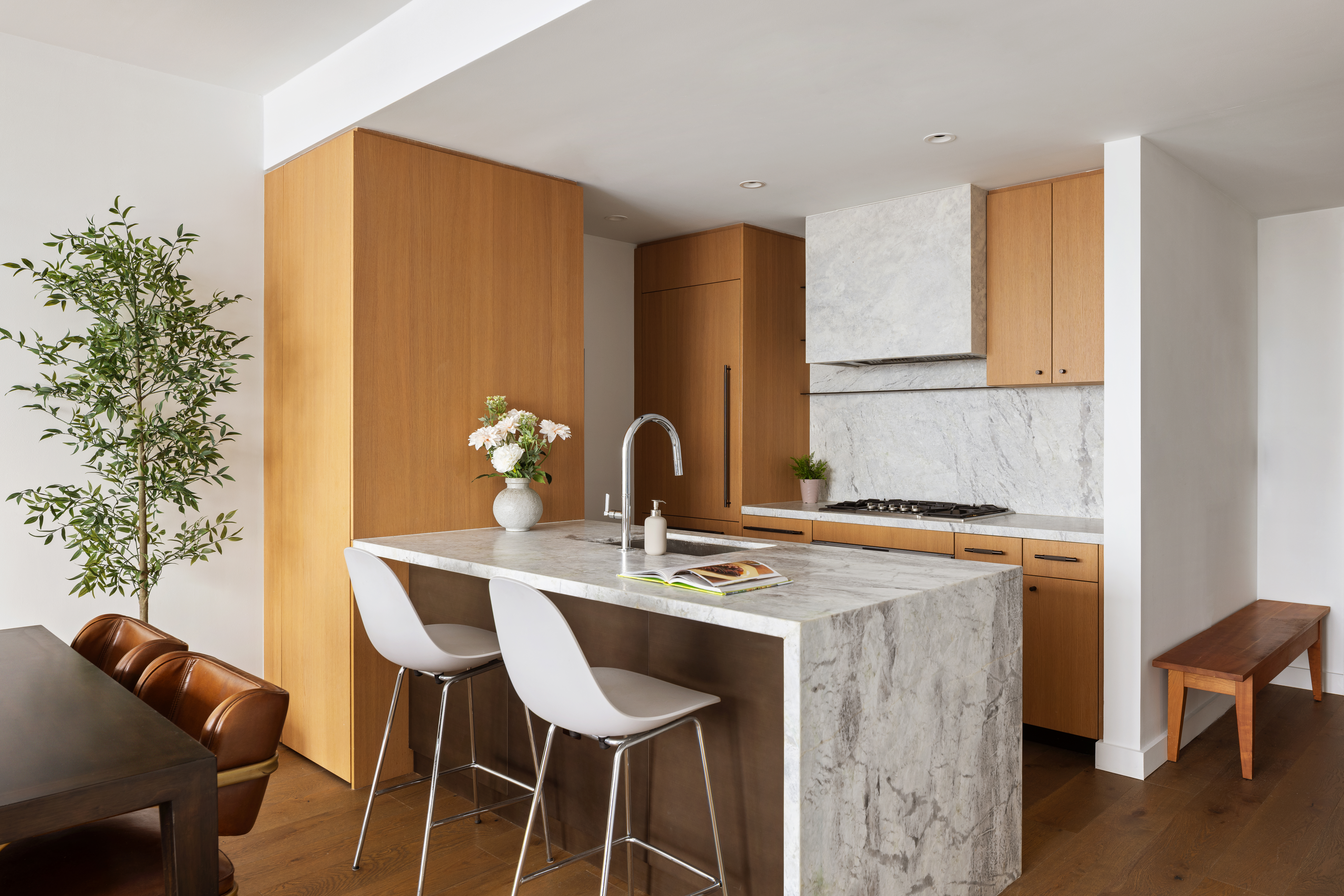 50 Bridge Park Drive, Unit 16E Brooklyn, NY 11201 - Photo 5 of 15 a dining table with chairs and a potted plant