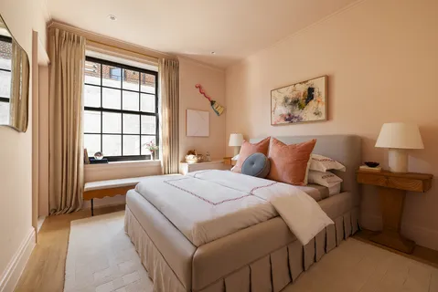 a spacious bedroom with a bed and a window