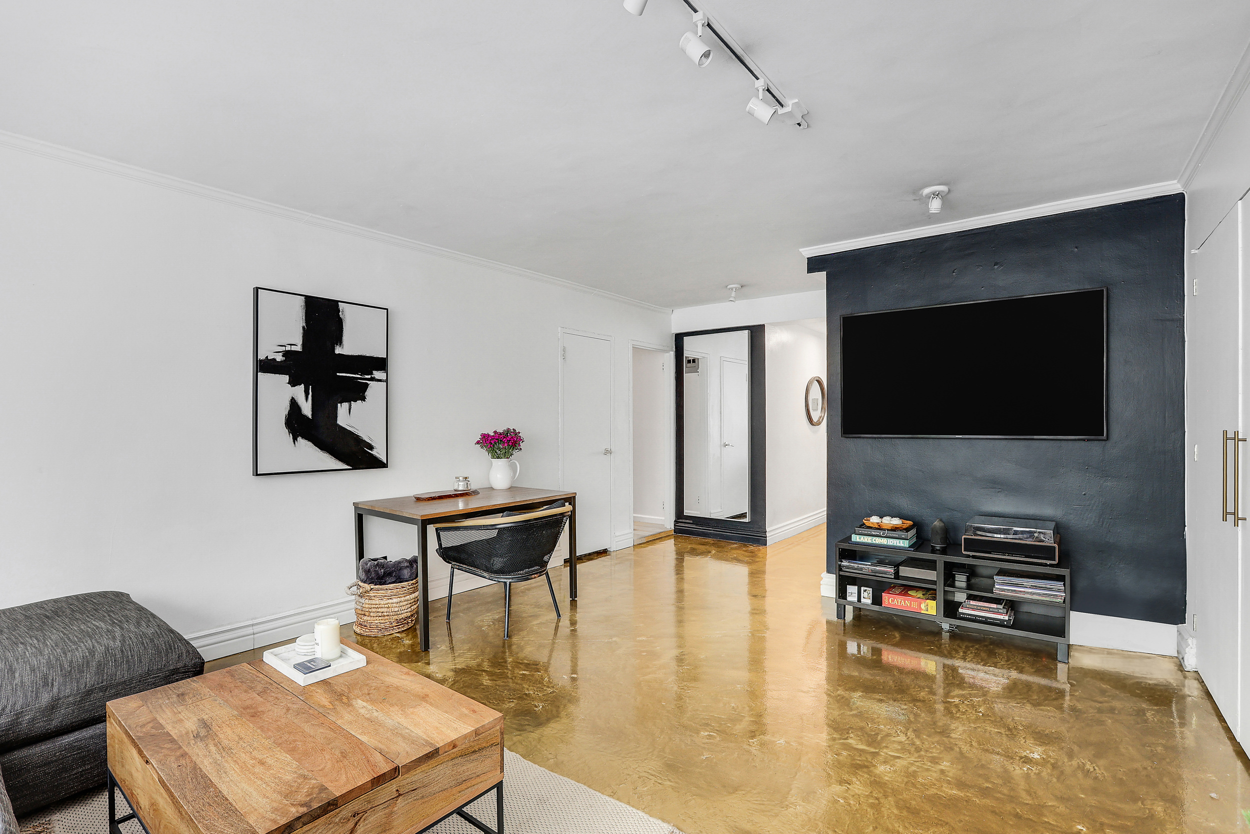 150 East 61st Street, Unit 2A Manhattan, NY 10065 - Photo 2 of 16 a living room with furniture and a flat screen tv