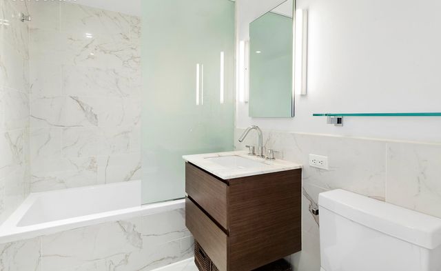 325 Lexington Avenue, Unit 10D Manhattan, NY 10016 - Photo 8 of 16 a bathroom with a sink a toilet and a bathtub