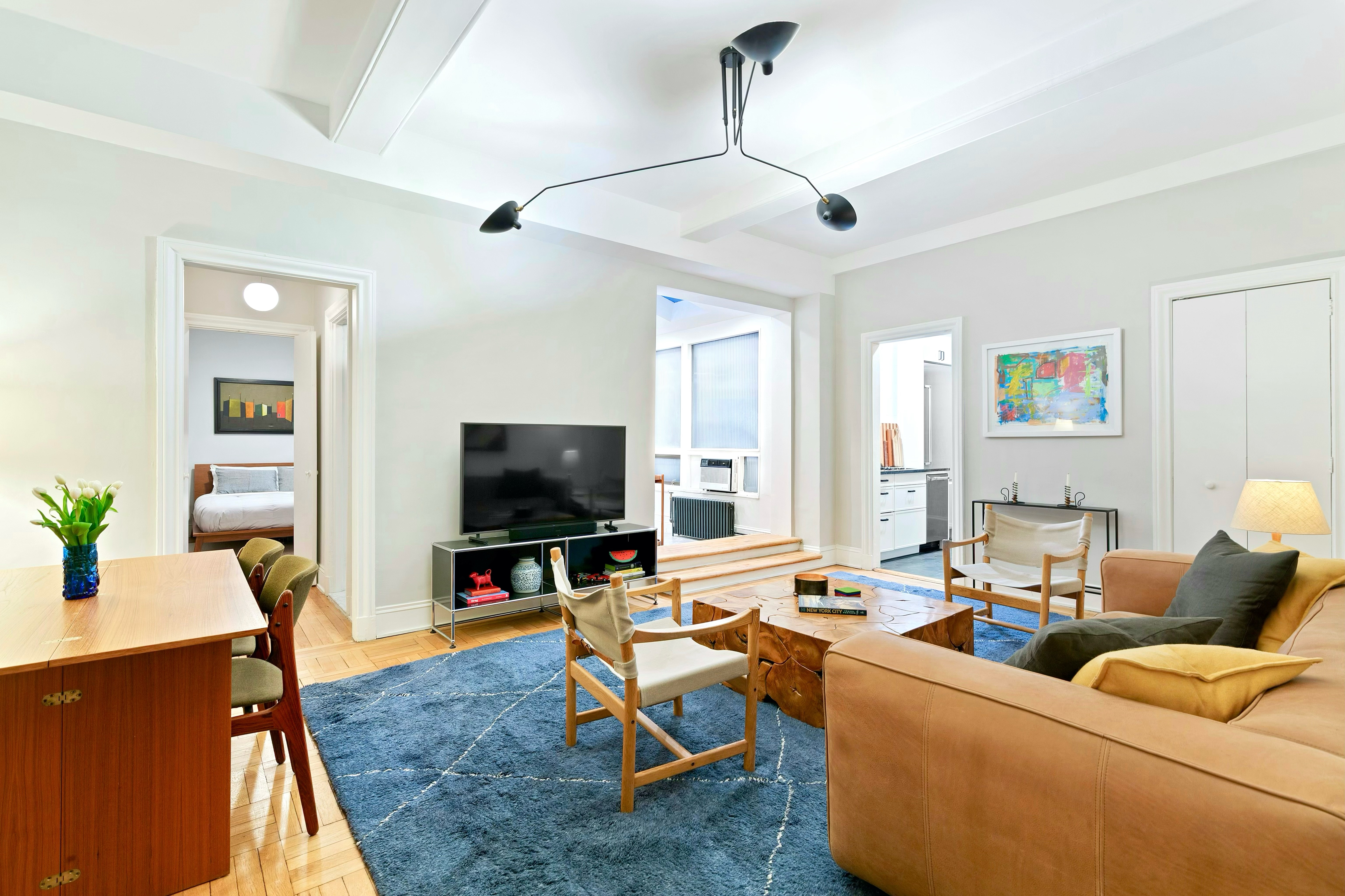 40 West 67th Street, Unit 1A Manhattan, NY 10023 - Photo 2 of 17 a living room with furniture and a flat screen tv