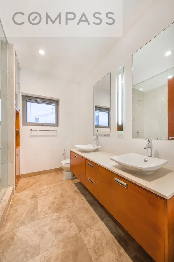 a large bathroom with a double vanity sink and a mirror