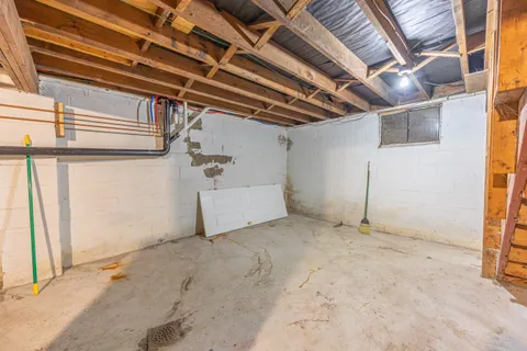 a view of empty room with wooden ceiling