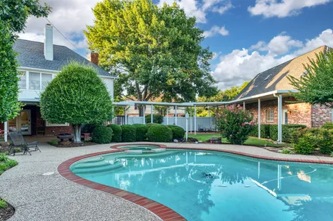 a view of a swimming pool with a patio