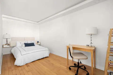 a room with a bed and a chair