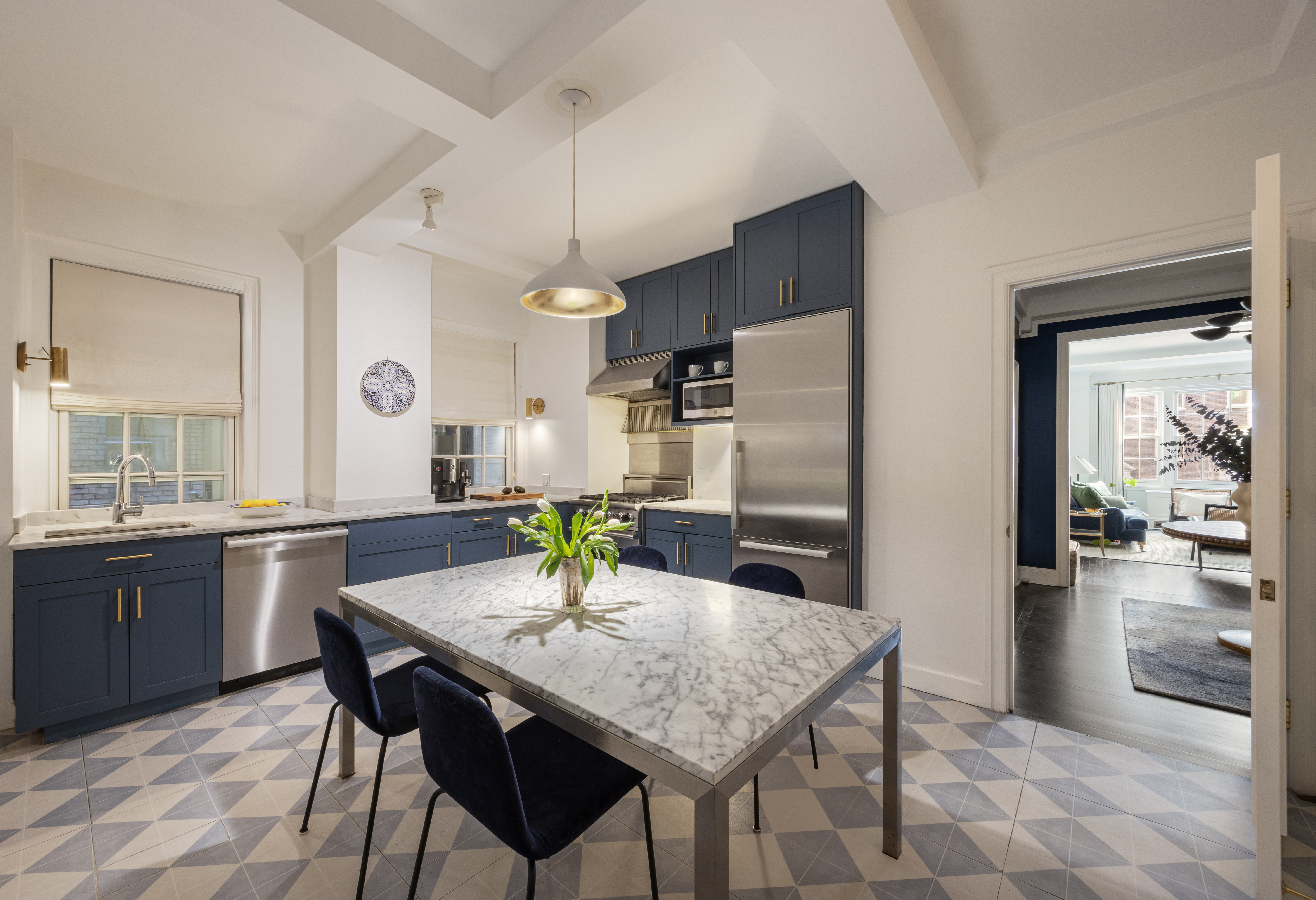 164 East 72nd Street, Unit 3B Manhattan, NY 10021 - Photo 3 of 11 a kitchen with granite countertop stainless steel appliances a sink and counter space