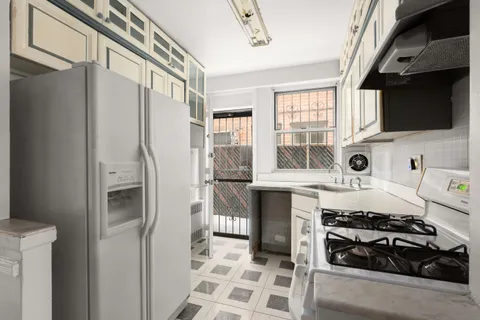 a kitchen with stainless steel appliances a stove a sink and a refrigerator