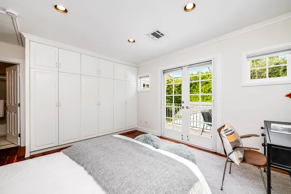 a bedroom with a bed a table and chair