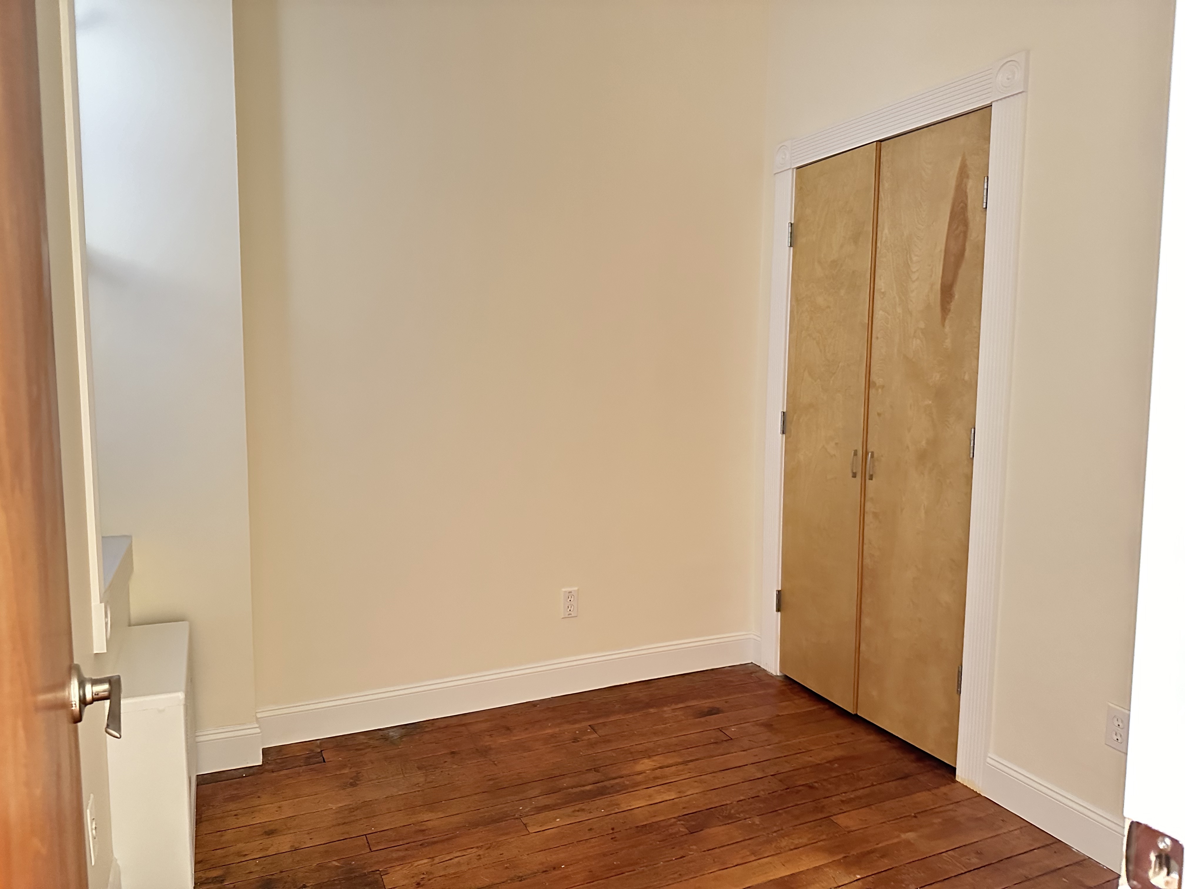 459 West 35th Street, Unit 1E Manhattan, NY 10001 - Photo 8 of 18 a view of an empty room with wooden floor