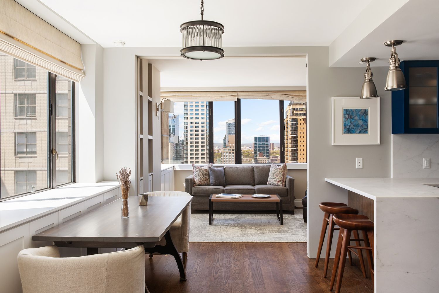 a living room with furniture and floor to ceiling windows