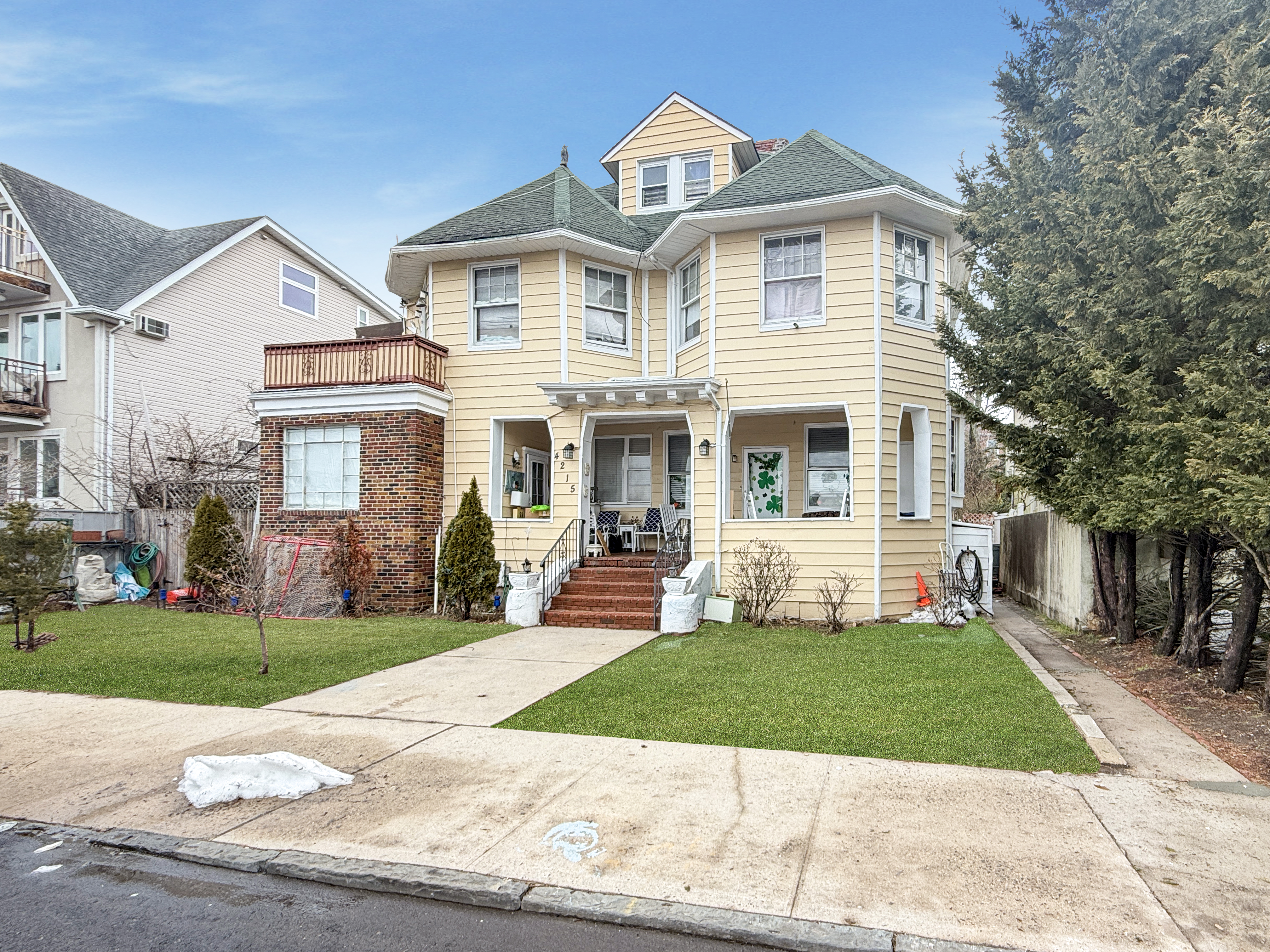 4215 Atlantic Avenue Brooklyn, NY 11224 - Photo 4 of 21 front view of a house next to a yard