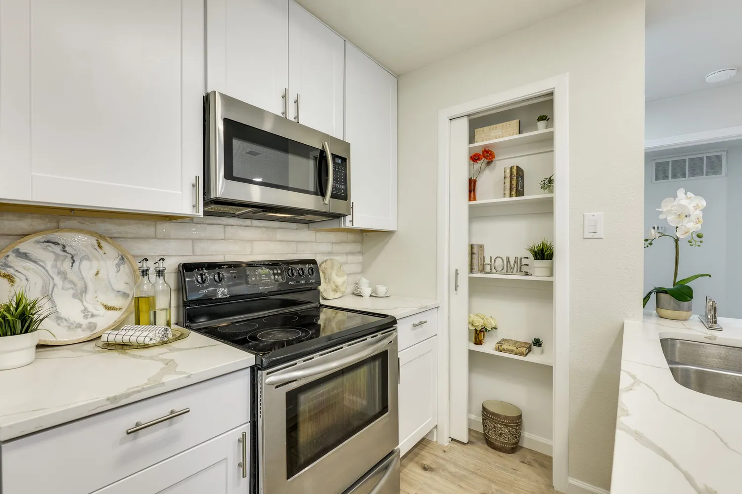 a kitchen with granite countertop a sink and a refrigerator