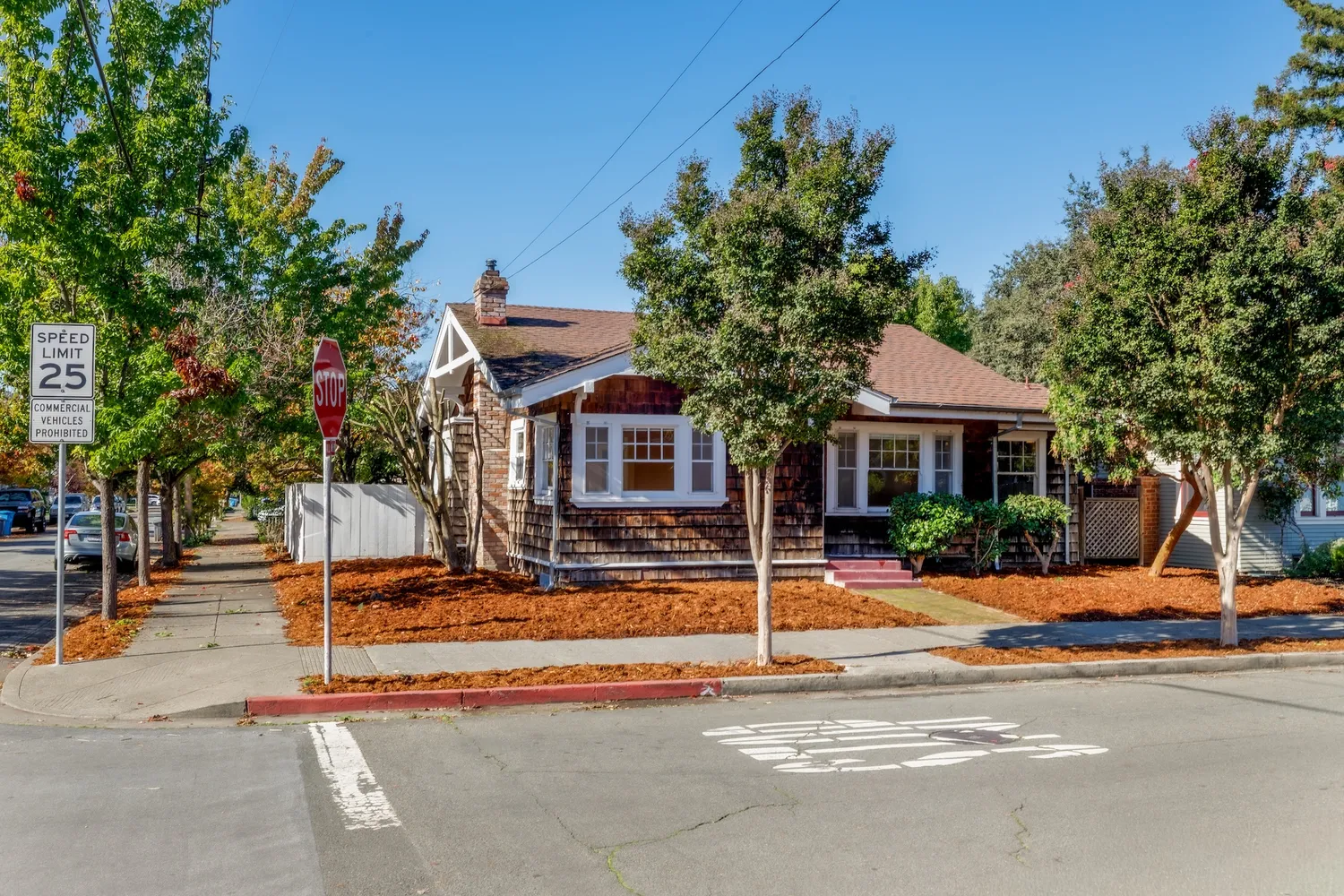 a view of a house with street and trees
