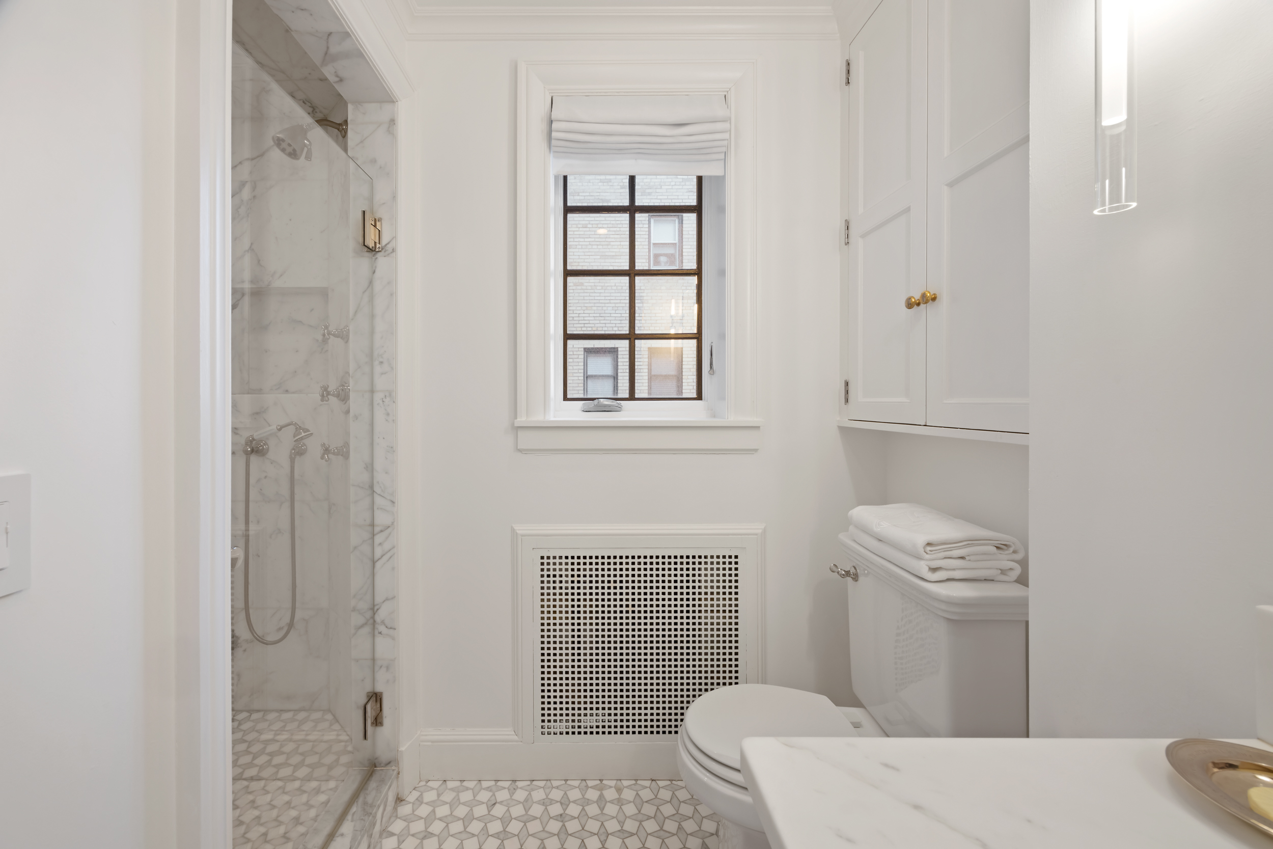 170 East 78th Street, Unit 8E Manhattan, NY 10075 - Photo 14 of 16 a bathroom with a sink a toilet and shower