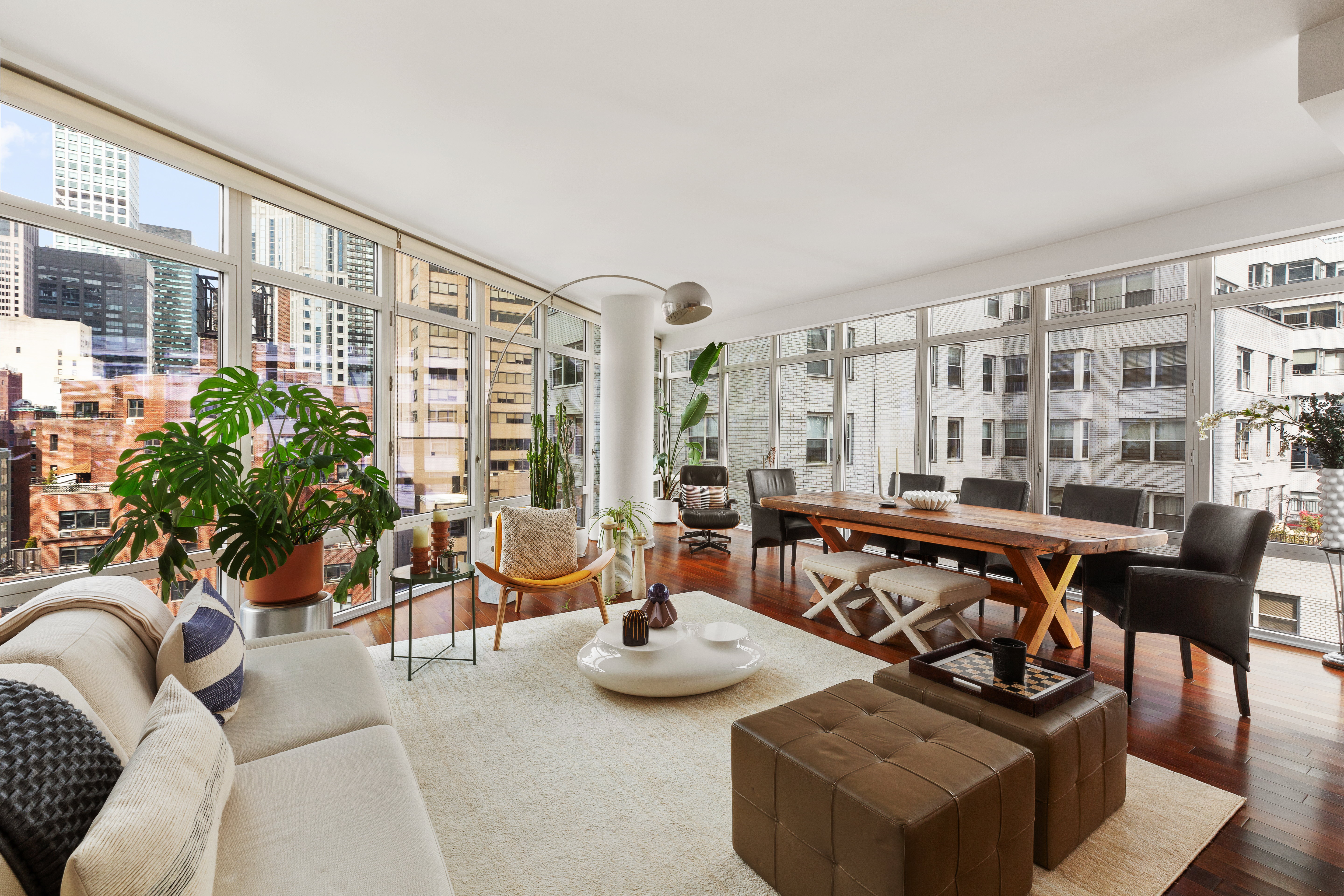 207 East 57th Street, Unit 18A Manhattan, NY 10022 - Photo 2 of 10 a living room with furniture and a large window