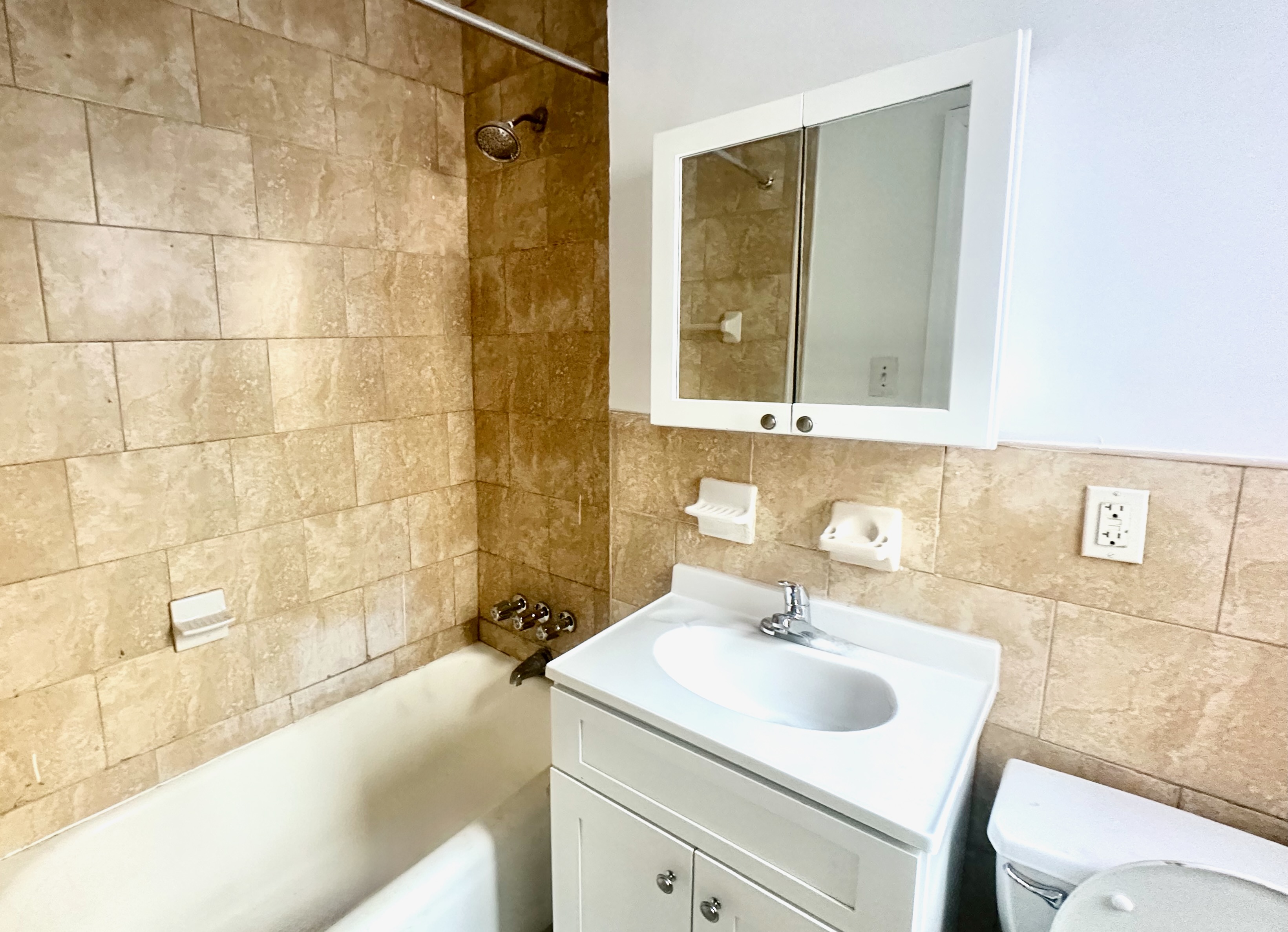 517 West 161st Street, Unit 4 Manhattan, NY 10032 - Photo 3 of 3 a bathroom with a sink and a bathtub