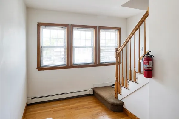 wooden floor with windows and stairs