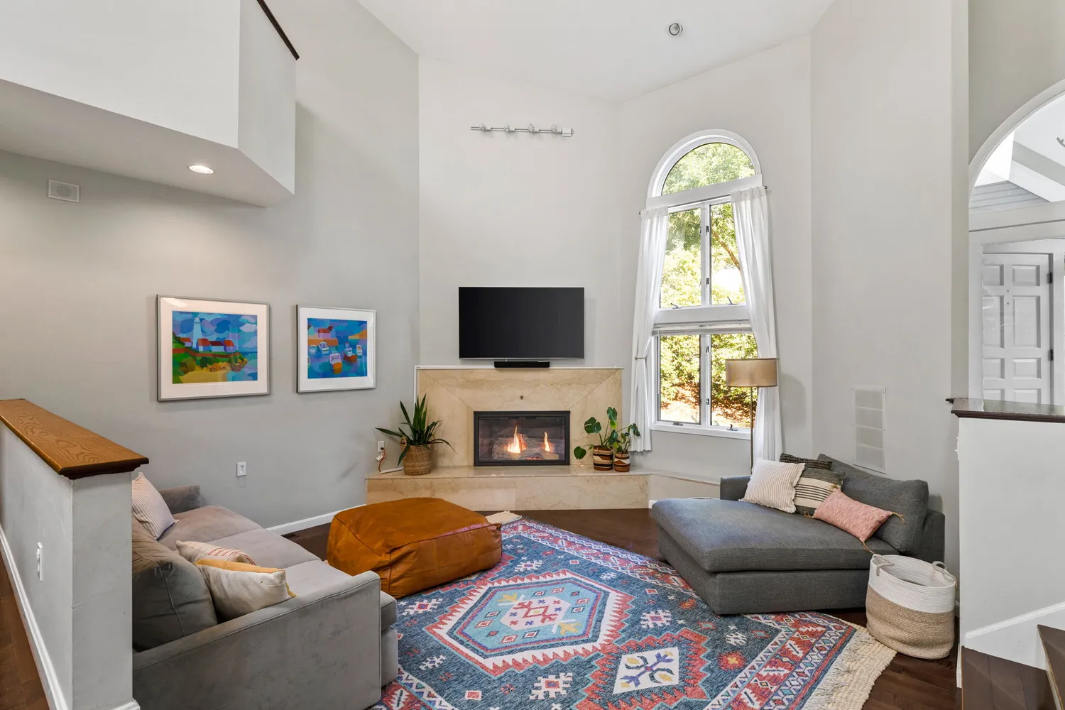 a living room with furniture a fireplace and a flat screen tv