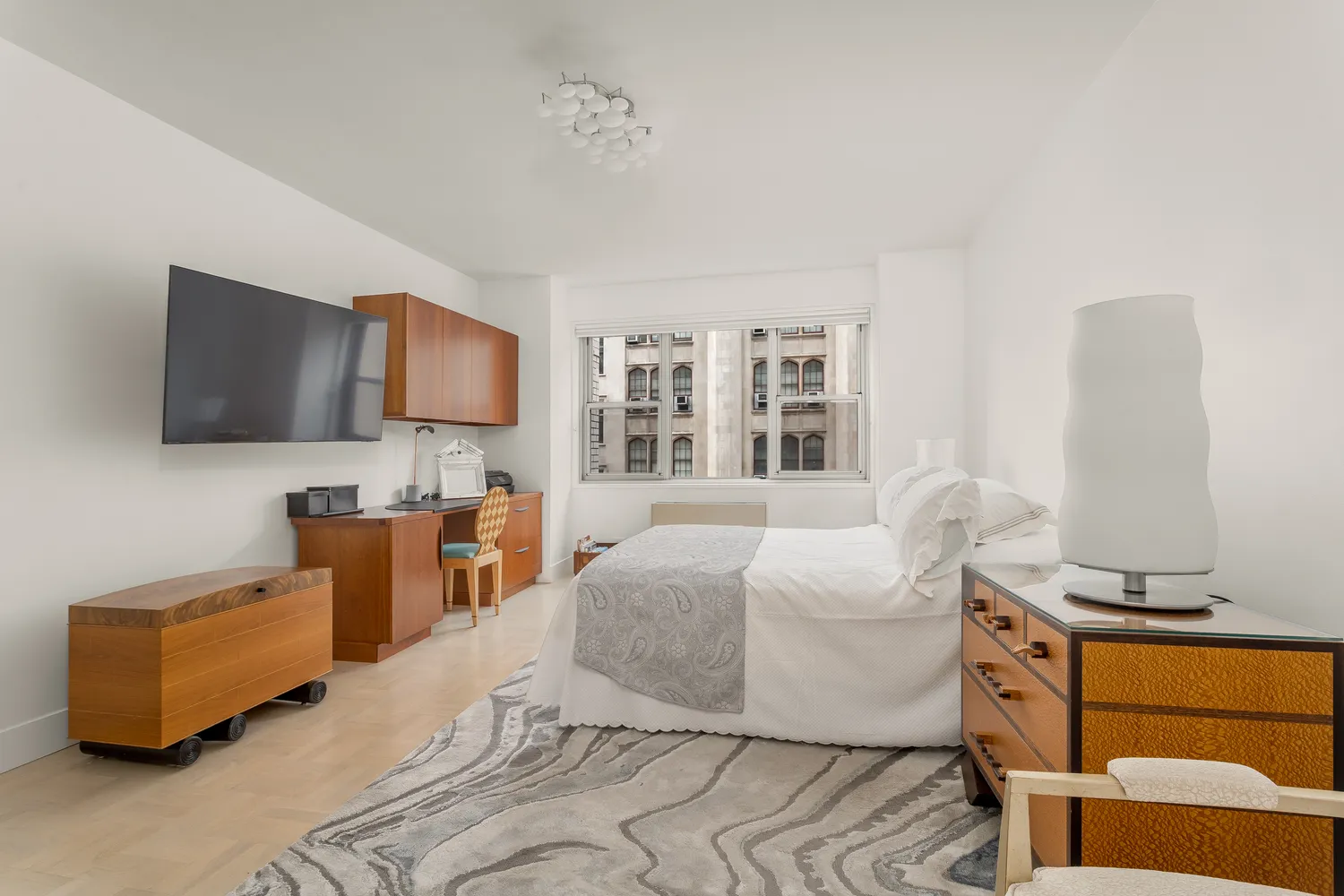 a bedroom with furniture and a flat screen tv