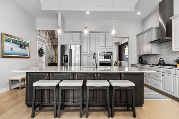 a kitchen with a table chairs sink and cabinets