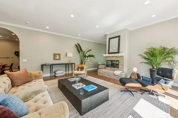 a living room with furniture a rug and a flat screen tv