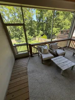 a living room with large trees and furniture