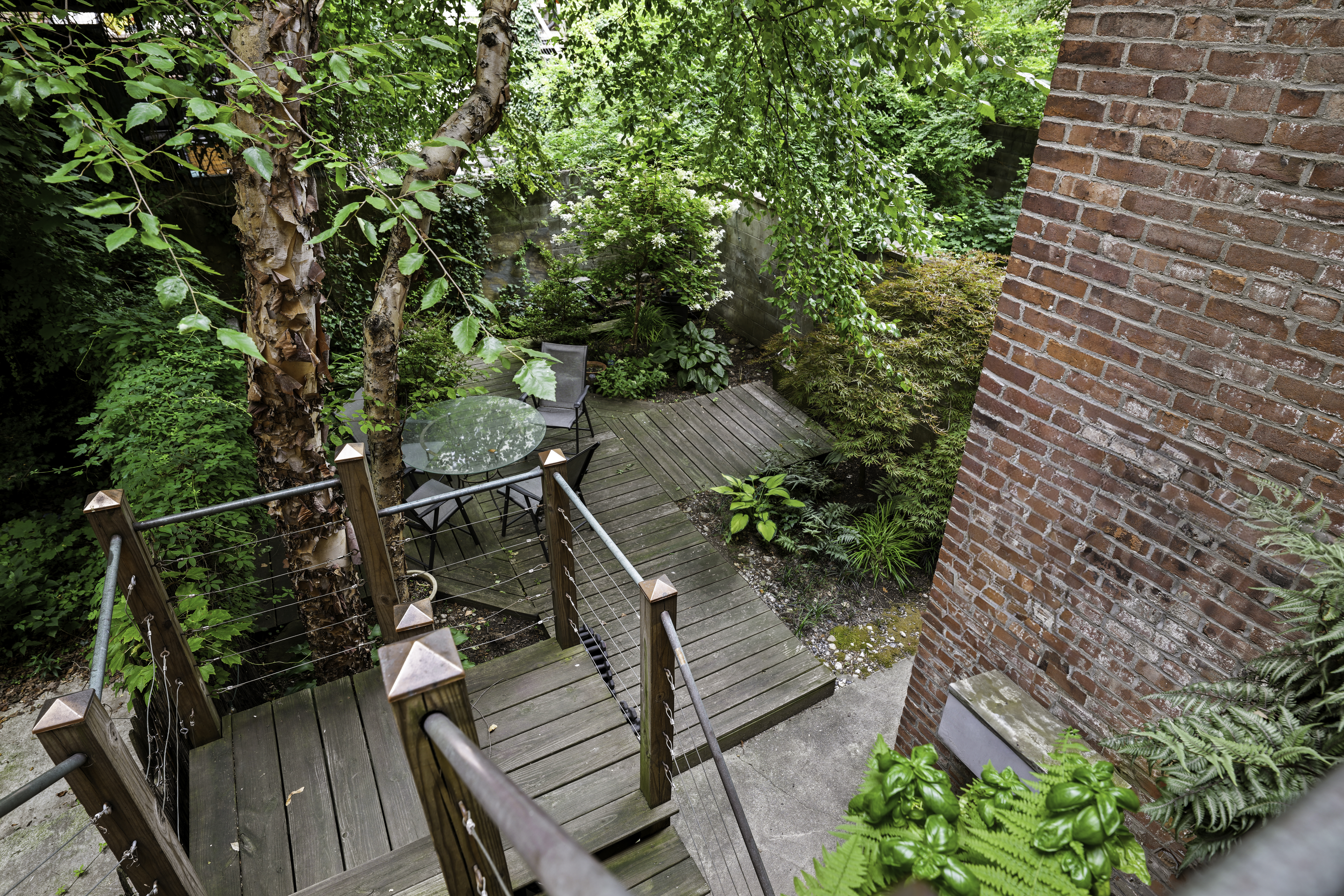 109 West 118th Street Manhattan, NY 10026 - Photo 27 of 31 a view of a balcony with wooden stairs and potted plants