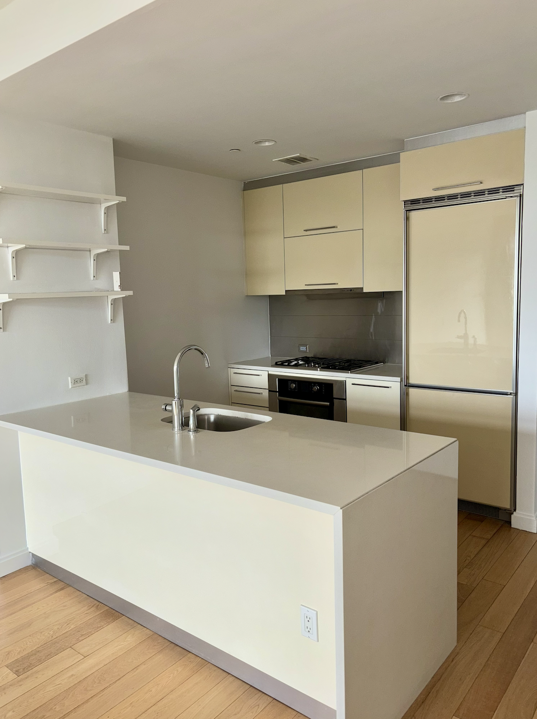 11-02 49th Avenue, Unit 2N Queens, NY 11101 - Photo 1 of 15 a kitchen with a refrigerator and a sink