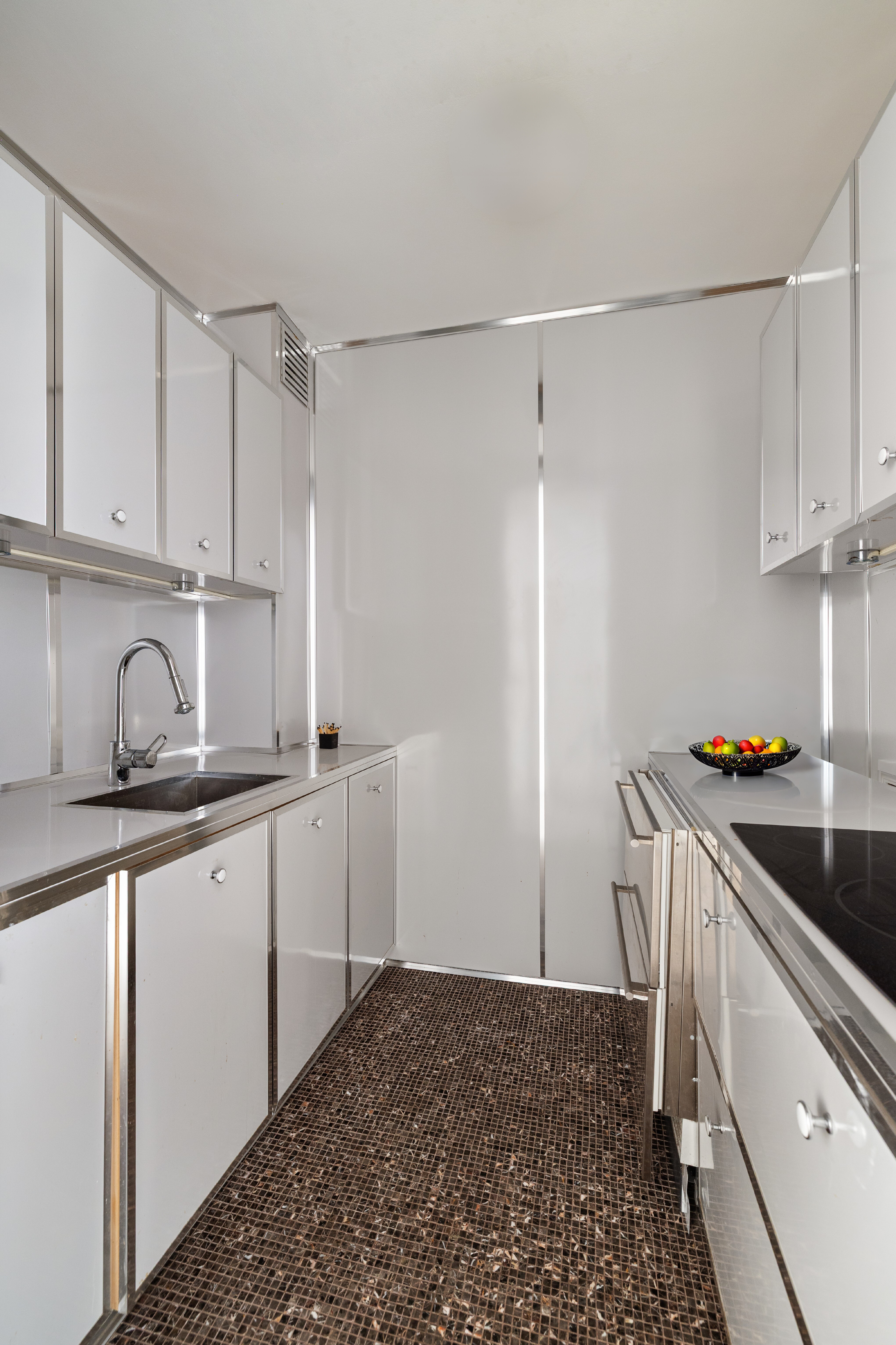 4 East 82nd Street, Unit 3F Manhattan, NY 10028 - Photo 6 of 9 a kitchen with stainless steel appliances granite countertop a sink and cabinets