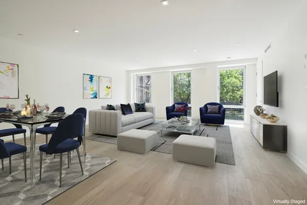 a living room with furniture flat screen tv and a large window