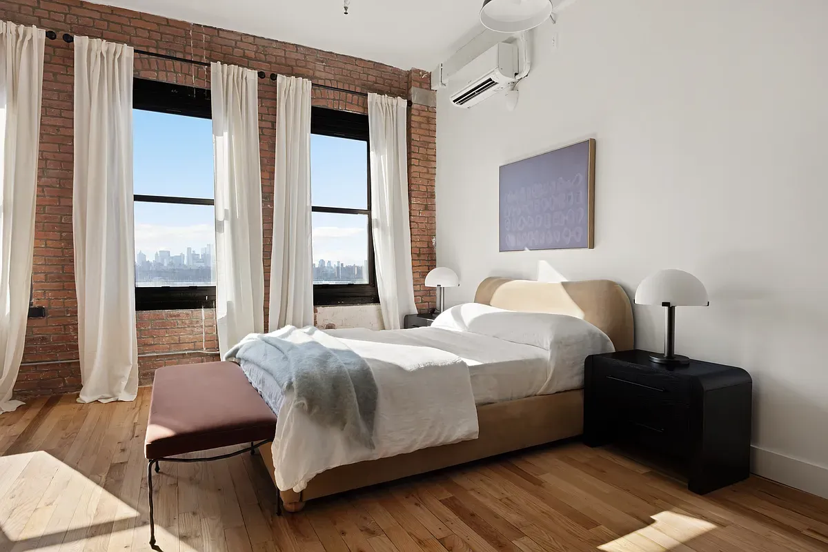 a bedroom with a bed lamp and a window