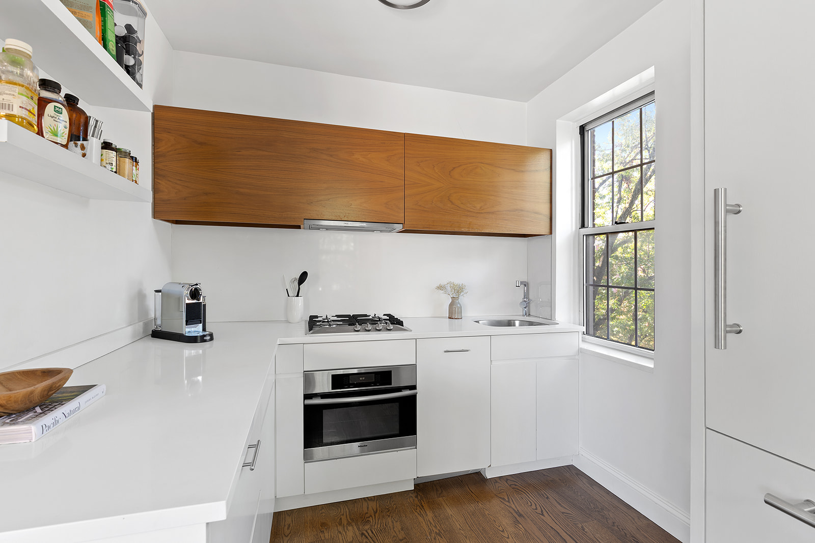 25 Minetta Lane, Unit 5C Manhattan, NY 10012 - Photo 4 of 7 a kitchen with stainless steel appliances a stove a sink and a refrigerator