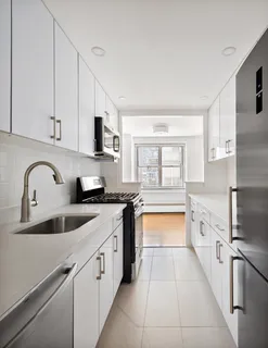 a kitchen with stainless steel appliances granite countertop a sink and a stove