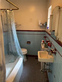 a bathroom with a sink toilet and a mirror