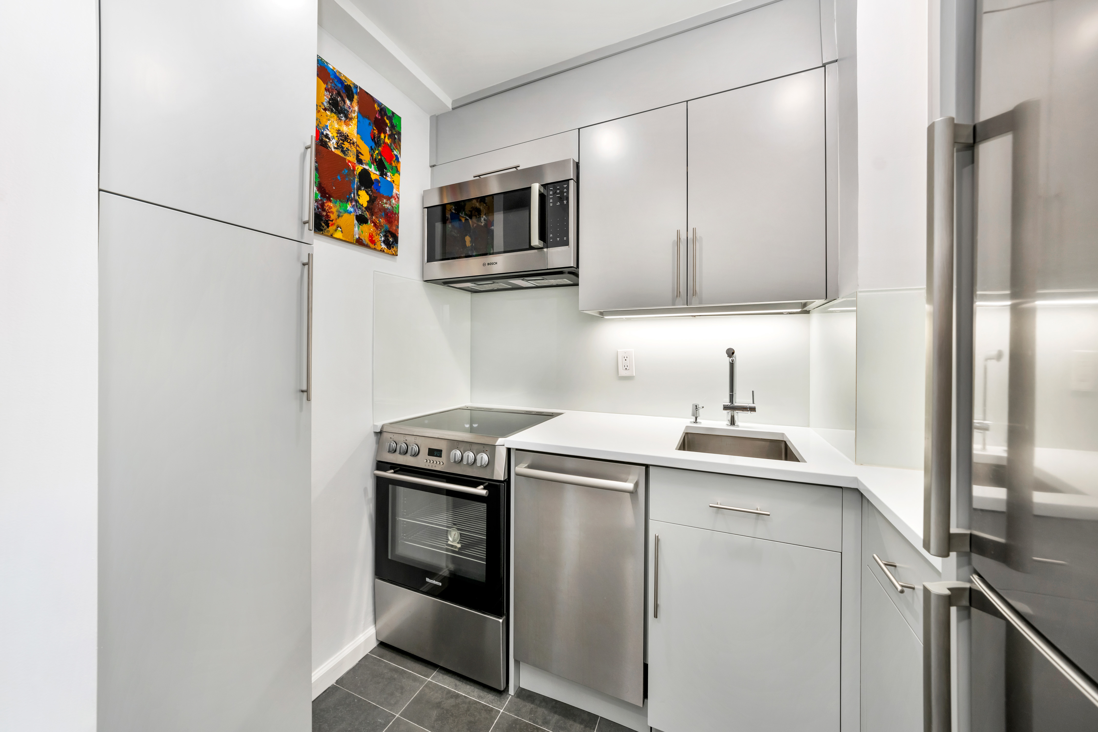 2 Tudor City Place, Unit 9OS Manhattan, NY 10017 - Photo 5 of 11 a kitchen with a sink and a stove top oven