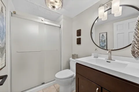 a bathroom with a sink a toilet and mirror
