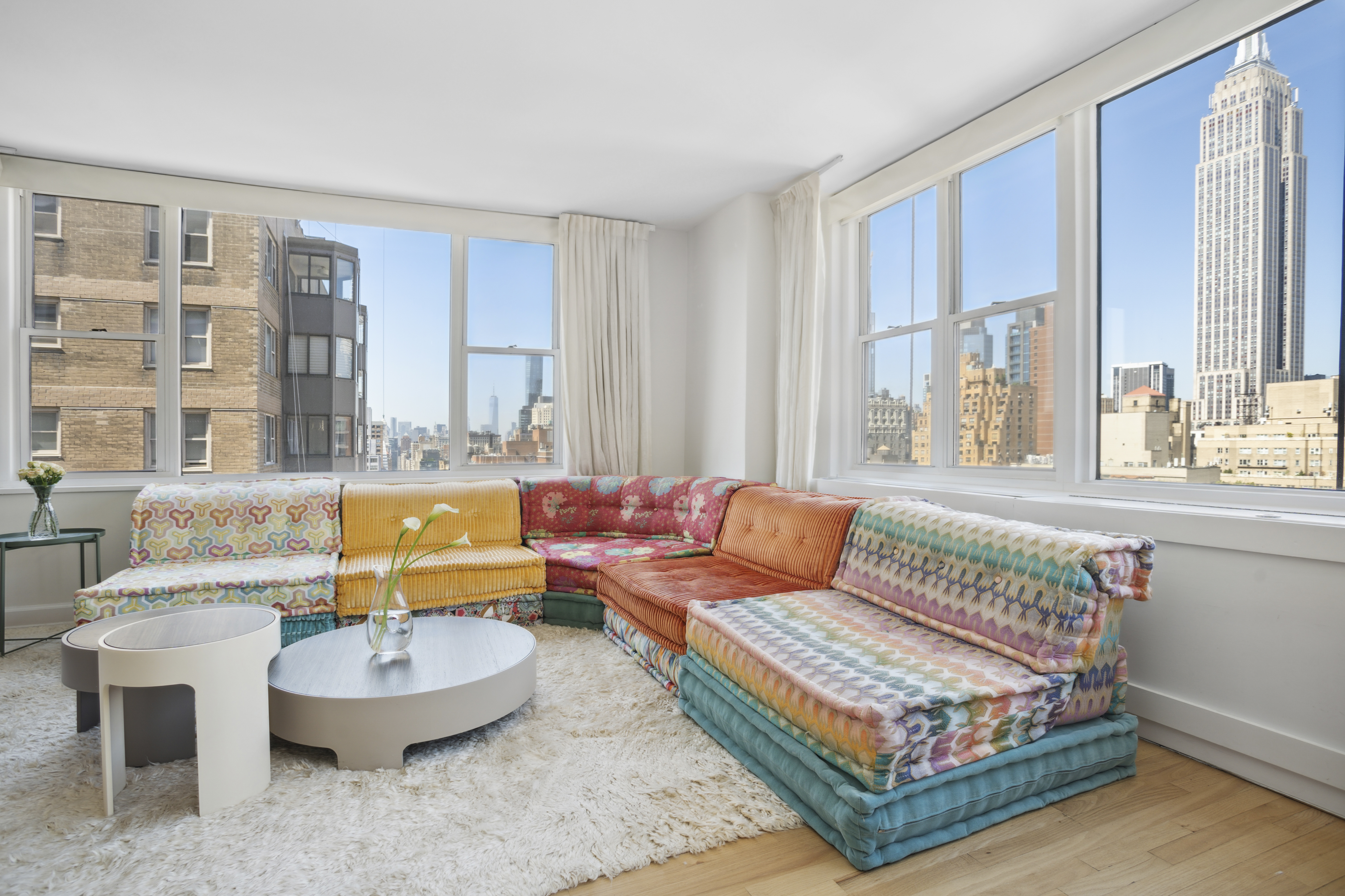 137 East 36th Street, Unit 21F Manhattan, NY 10016 - Photo 2 of 20 a living room with furniture and a large window