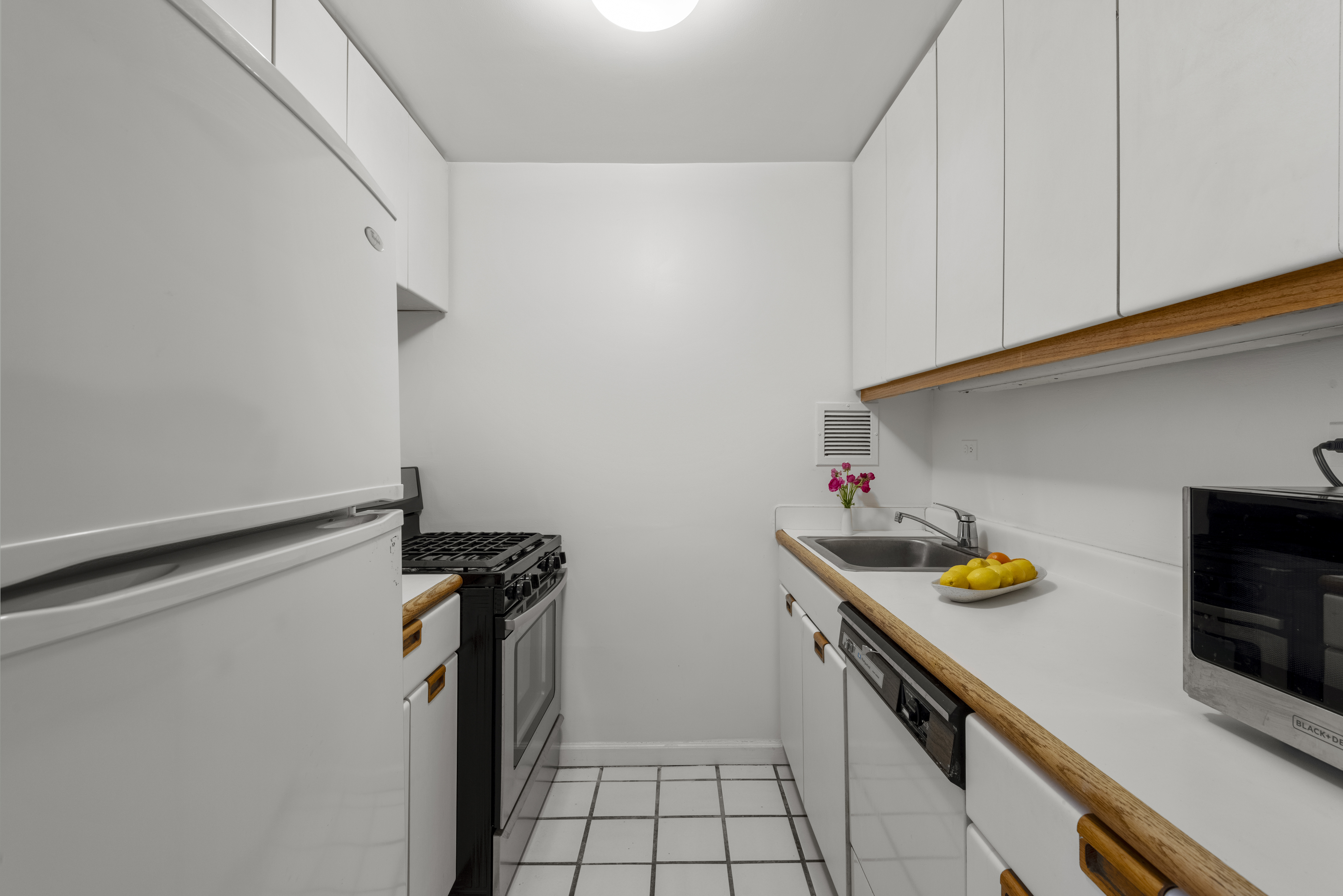 45 West 67th Street, Unit 14D Manhattan, NY 10023 - Photo 9 of 13 a utility room with dryer and washer