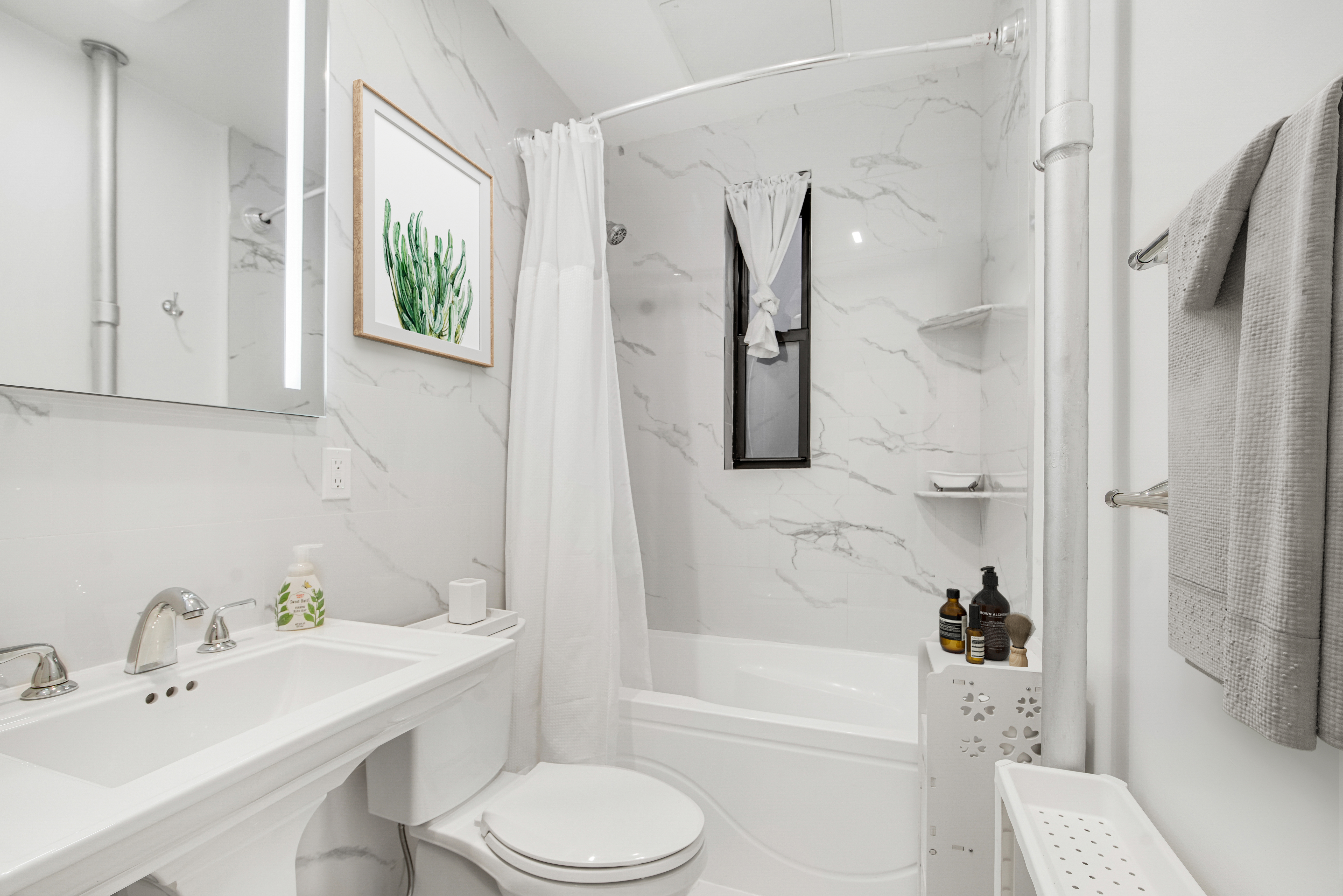 1878 Adam Clayton Powell Jr Boulevard, Unit 52 Manhattan, NY 10026 - Photo 5 of 13 a bathroom with a sink toilet and shower