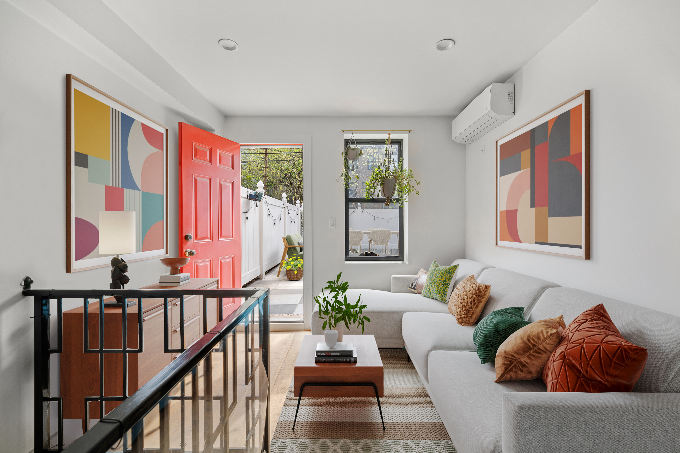a living room with furniture and paintings on the wall