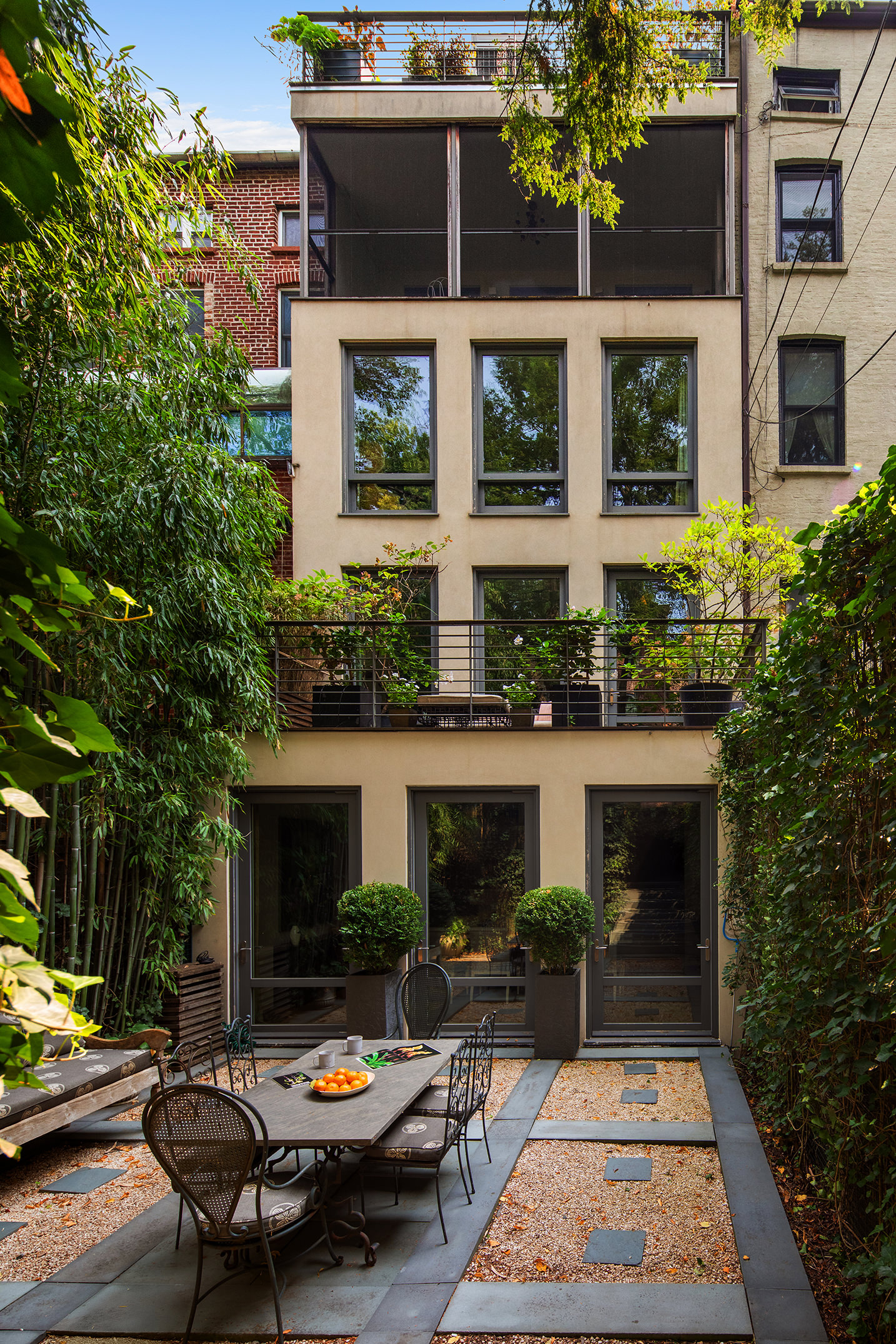 12 Sidney Place Brooklyn, NY 11201 - Photo 18 of 36 a backyard of a house with fire pit table and chairs
