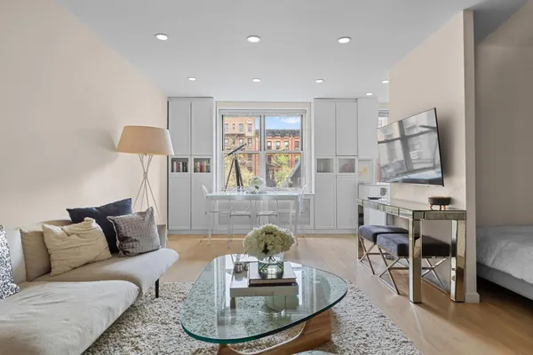 a living room with furniture and a wooden floor