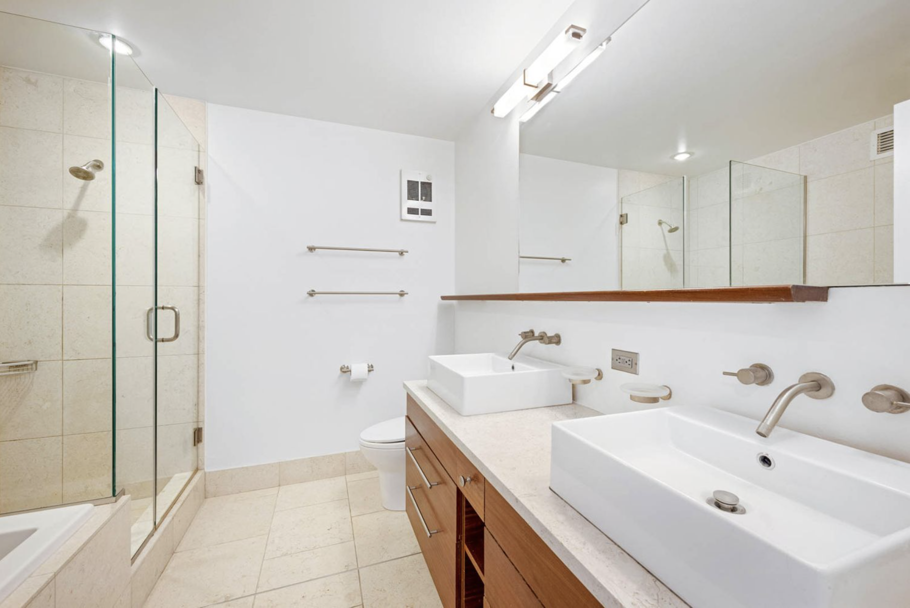 225 West 60th Street, Unit 8F Manhattan, NY 10023 - Photo 5 of 11 a bathroom with a sink a toilet and shower