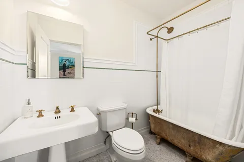 a white toilet sitting next to a bathroom sink