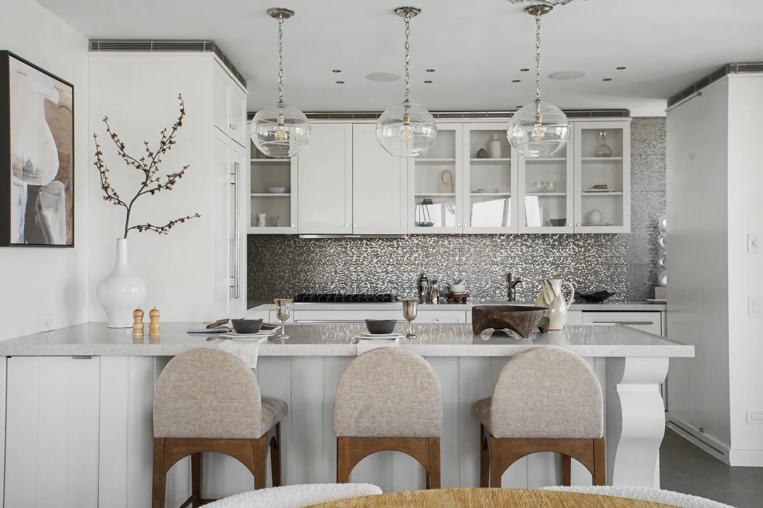 a kitchen with stainless steel appliances granite countertop a table and chairs in it